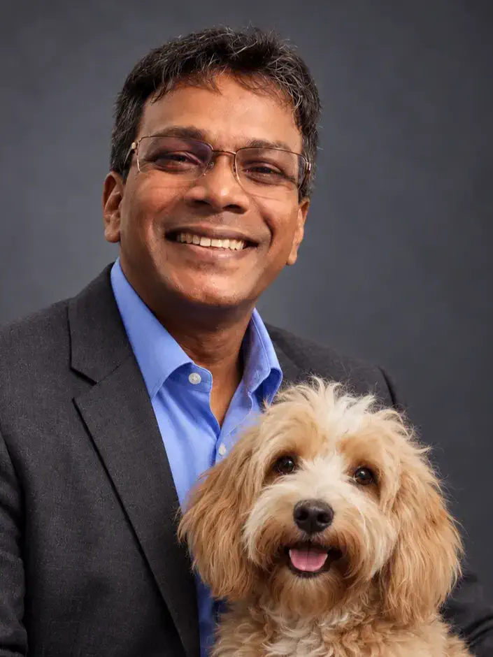 Ishar Fernando smiling with Simba, his dog